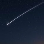 Quadrantid meteor shower streaking across a starry night sky.