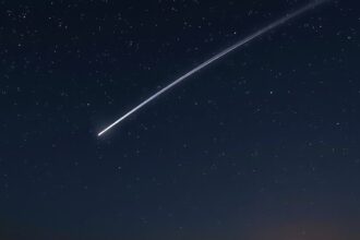 Quadrantid meteor shower streaking across a starry night sky.